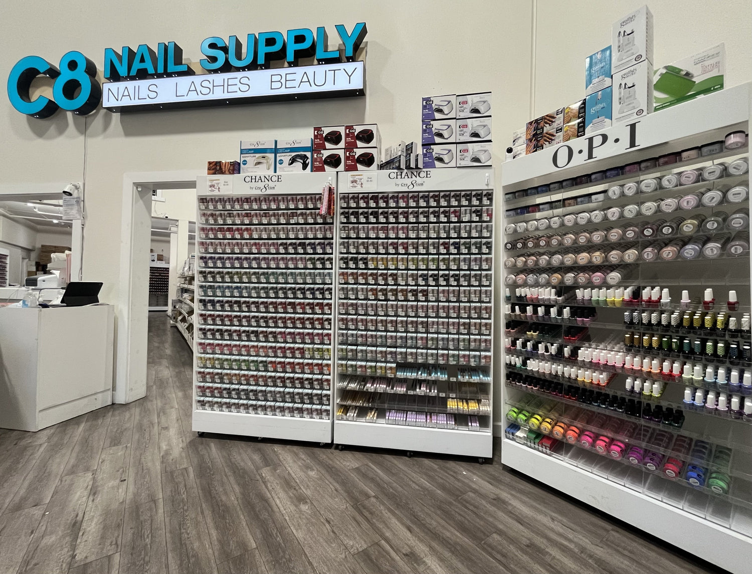 Storefront and lobby of C8 nail supply and a full shelf of products that we have to offer. On the right shelf there is an OPI shelf of products. Nail store, Nail Supplies, Nails, Nail supply store, Nail supply, OPI, Chance, Cre8tion, Acrylic Powder, Nail Lacquer, Nail Gel, Gel Polish, Nail Polish, nails, nail supply, nail supply store, nail store, nail supplies, c8 nail supply